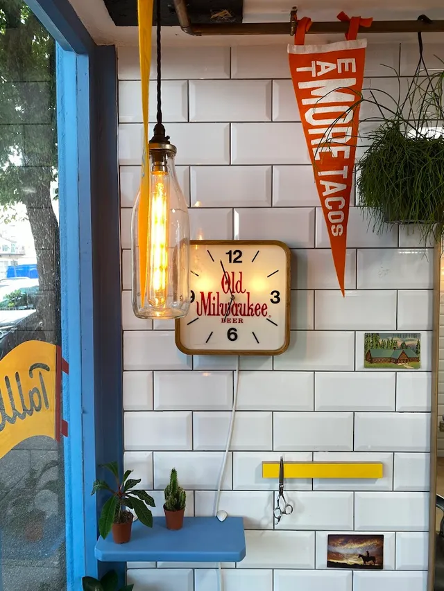 Subway tiles, a wall clock and an Eat More Tacos pennant at Tallboys